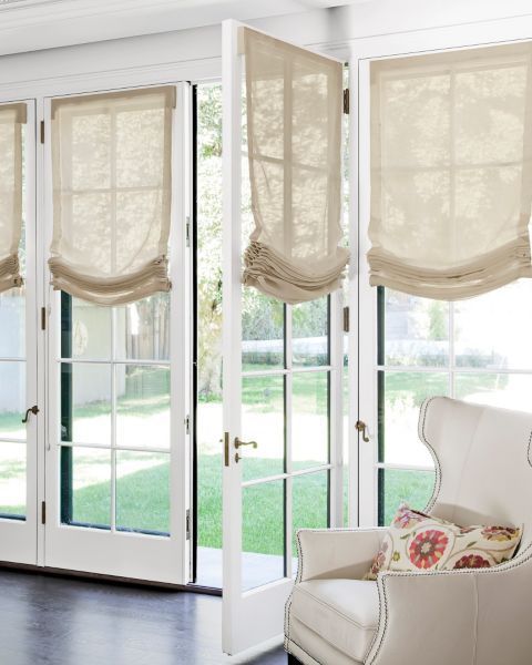 French windows styled with semi sheer neutral Roman shades look very chic, elegant and add coziness to the space