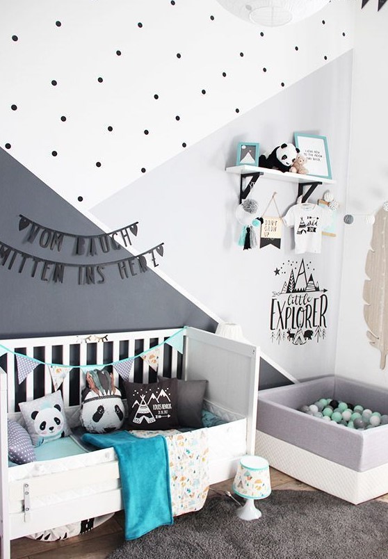 a Nordic kids' room with a white bed, a box with balls, a shelf with holders, color block and polka dot walls