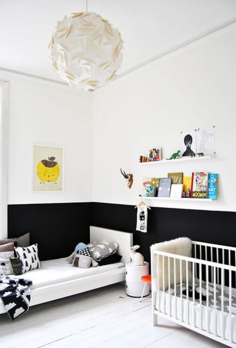 a Scandinavian kid's room with color block walls, a couple of beds, some ledges for books and colorful books