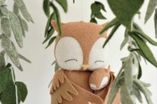 a baby mobile with a couple of owls and leaves is a cozy idea for a forest or just neutral and relaxed nursery