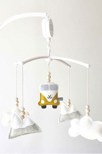 a boho nursery mobile with clouds, mountains, a van and wooden beads is a very cool and fun idea for a boho space