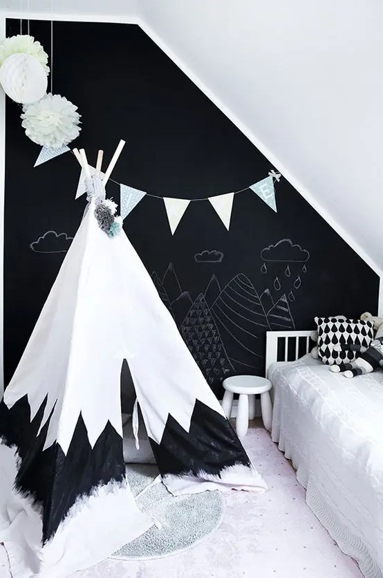 a kids room with a chalkboard accent wall