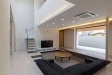 a clean minimalist space with a sunken conversation pit with much negative space for an airy feeling