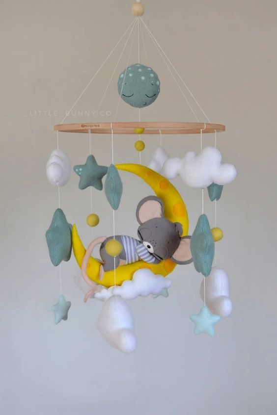 a colorful mobile with clouds, stars and a mouse sleeping on a half moon is a super cute and cool idea