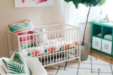 a colorful tropical-inspried small nursery with floral, palm prints, potted greenery and artworks