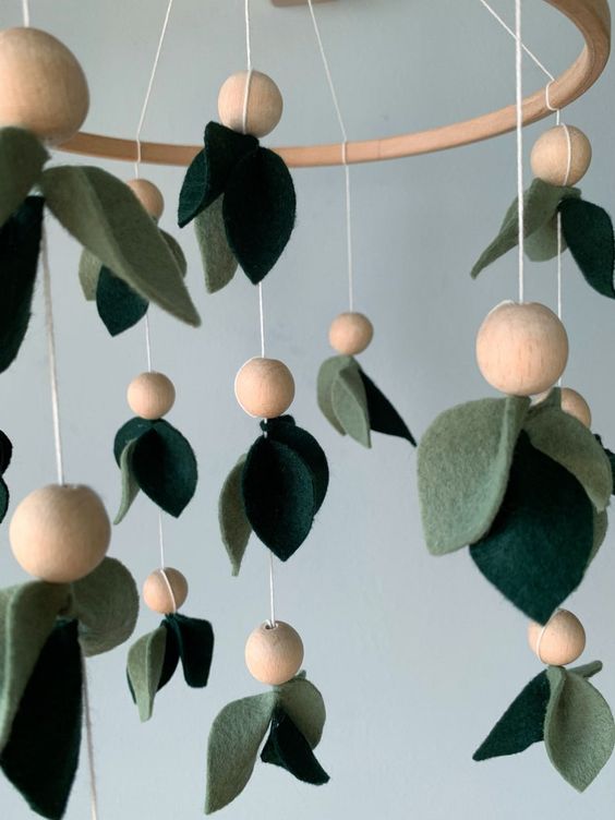 a cool green felt leaf mobile with wooden beads is a cool idea with a botanical touch, it will work for most of nurseries