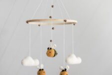 a cool mobile of bees and clouds that are crochet is a super cool and cute idea to rock