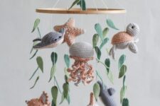 a cool ocean crochet nursery mobile with whales, fish, jellyfish, starfish and some seaweed is a cozy and lovely idea