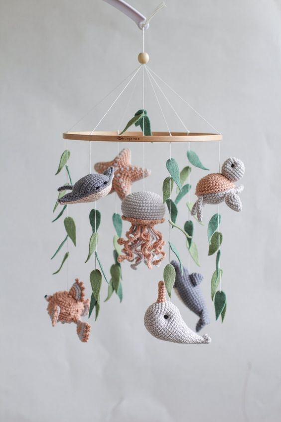 a cool ocean crochet nursery mobile with whales, fish, jellyfish, starfish and some seaweed is a cozy and lovely idea