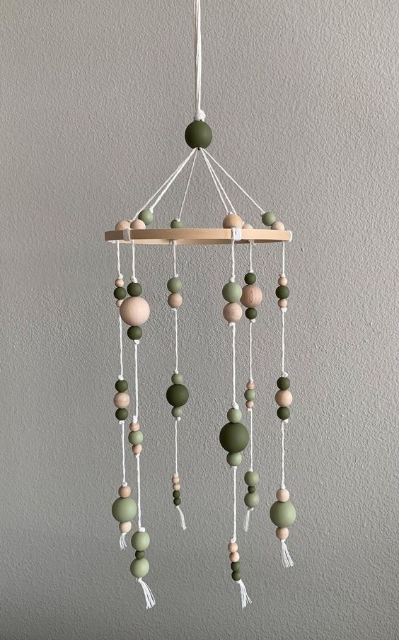 a cool wooden bead mobile with neutral and green wooden beads is a super cool idea for any space