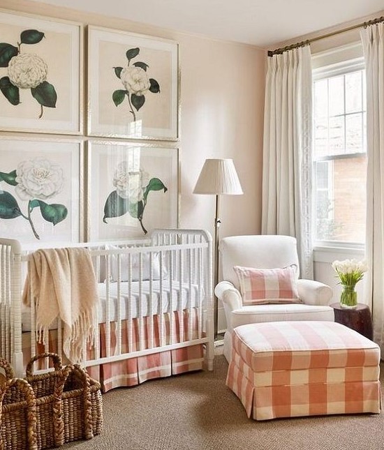 a cozy farmhouse nursery with peach and white plaid textiles and flower artworks may be nice for a girl's space