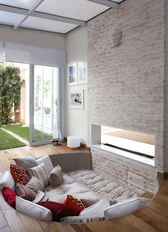 a cozy little round conversation pit next to the fireplace is a very cool idea to spend time at the fire