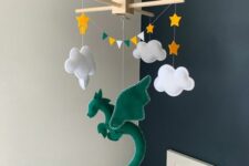 a creative and bold nursery mobile with a green dragon, clouds, stars and a colorful bunting is a cool and bright solution