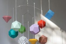 a creative and colorful 3D geometric paper mobile is a good idea for a colorful modern nursery and you can make one yourself
