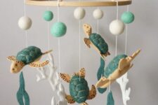 a gorgeous turtle mobile with turtles, corals, sea weed and pompoms done of green and white felt is a cool idea for a beach nursery