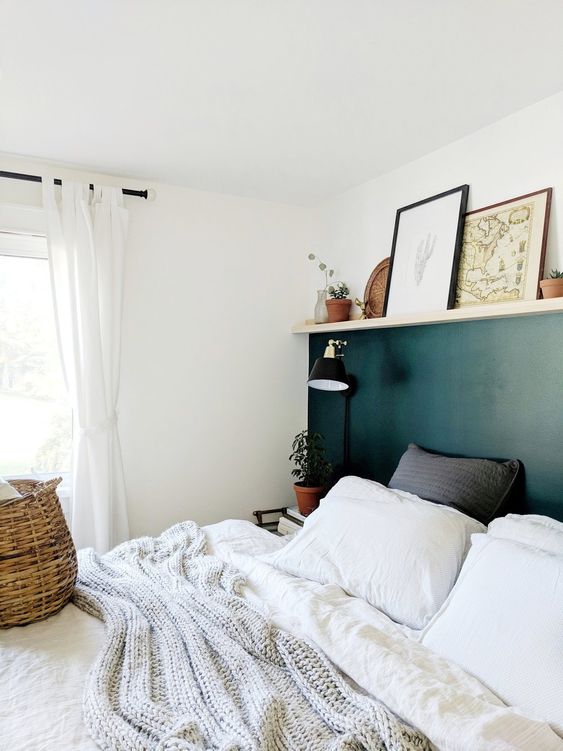 a ledge helps to divide the wall into hunter green and white part and accent it and allows displaying artworks and potted plants