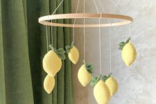 a lovely and bold yellow felt lemon mobile with leaves is a cool and chic idea for a botanical-themed space or a Mediterranean one