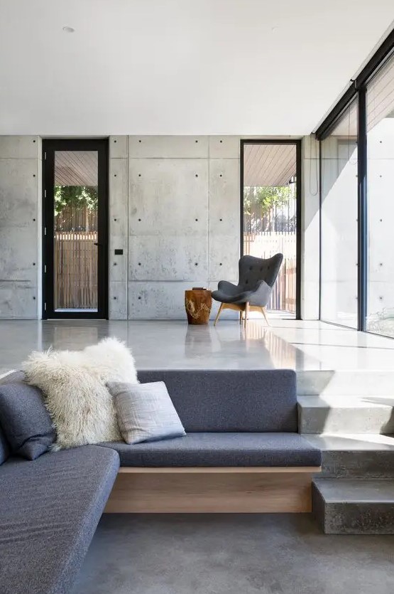 a minimalist sunken conversation pit with upholstered furniture and much negative space around