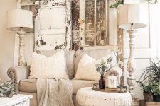 a neutral shabby chic living room with stylish furniture, potted greenery, shabby shutters and tall floor lamps
