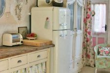 a neutral shabby chic space with refined vintage furniture, floral curtains instead of doors, floral textiles and a wall sconce