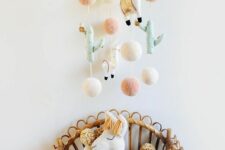 a pastel desert mobile with cacti, pompoms and llamas is a cool idea for a boho or desert nursery