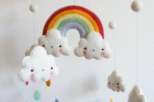a pretty and bright mobile with a rainbow, clouds and colorful felt raindrops is a cool and fun idea for any nurseries