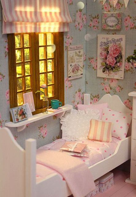 a shabby chic bedroom with floral walls, white furniture, pretty pink and striped bedding, a striped curtain and vintage posters