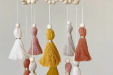 a simple boho mobile with colorful tassels and wooden beads is a stylish boho idea that can be realized yourself