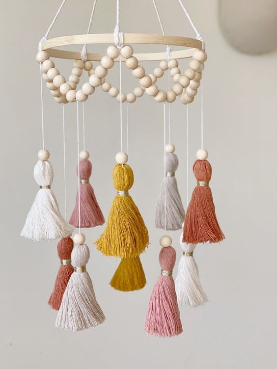 a simple boho mobile with colorful tassels and wooden beads is a stylish boho idea that can be realized yourself