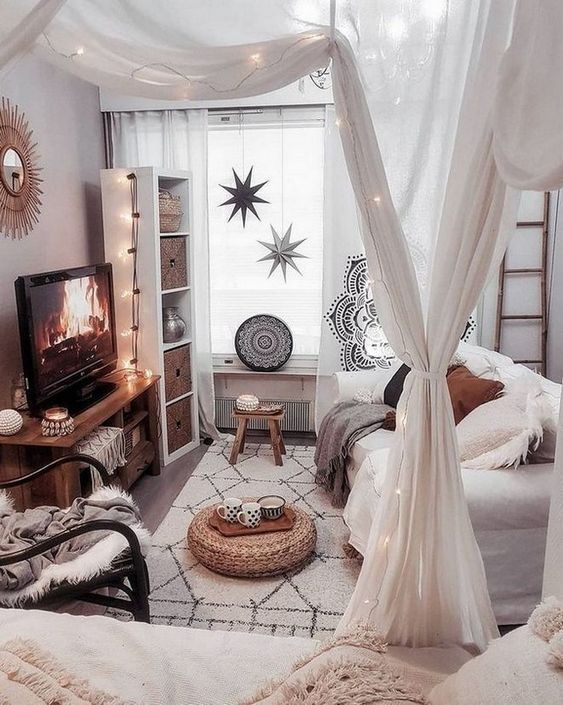 a small boho living room accented with mosquito net curtains and lights interwoven