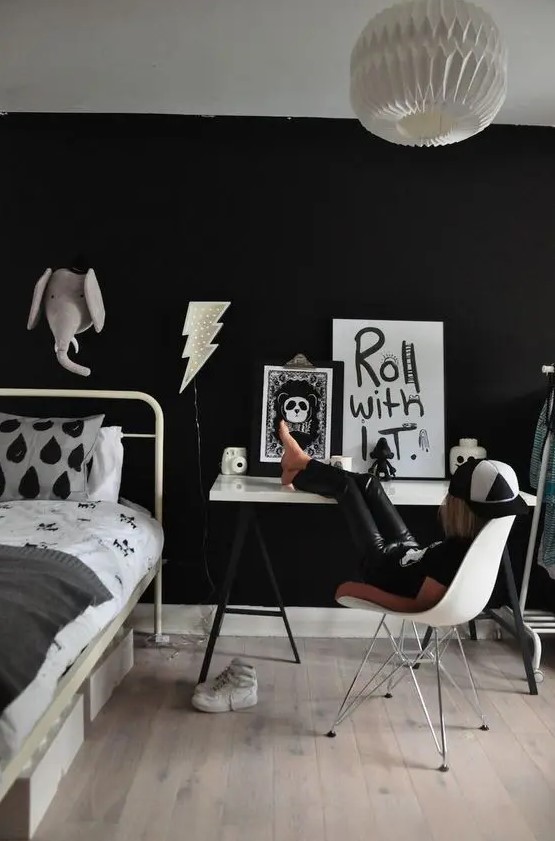 a stylish black and white space for a little rock n roller should be done with a black wall, of course
