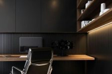 a stylish moody minimalist home office with a wood slab wall and a sleek storage unit, an open shelving unit and a floating desk plus a black chair