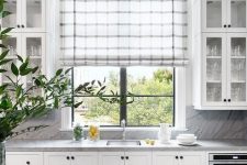 a subtle grey and white plaid Roman shade is a cool accent and addition of a print to the farmhouse space is lovely
