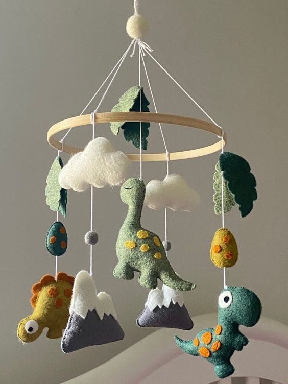 a super creative and fun dinosaur mobile with clouds, eggs, mountains and leaves is a colorful and vivacious idea