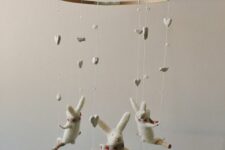 a super cute bunny mobile with bunnies on swings and hearts and beads is a cool and cute idea that will fit any nursery