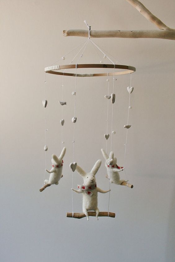 a super cute bunny mobile with bunnies on swings and hearts and beads is a cool and cute idea that will fit any nursery