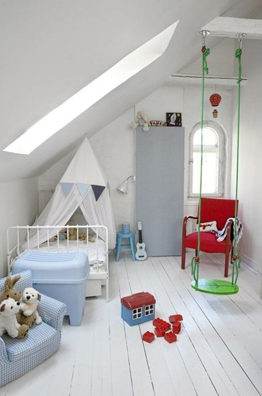 a white attic nursery with colorful furniture and toys, with a swing is very fun and veyr welcoming