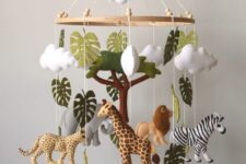 an African-themed nursery with savanna naimals, monstera leaves and clouds is a super cool and bold idea for the space