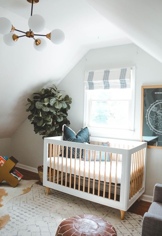 an eclectic nursery with black and white decor, with a statement potted plant, layered rugs, a leather ottoman