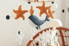 an ocean mobile with corals, a whale and star fish plus a jellyfish is a cool and lovely idea for an ocean space