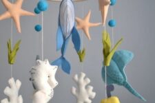 an under the sea mobile with corals, starfish, whales, fish and a submarine is a fun idea for an ocean space