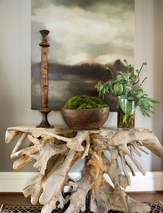 a bold and beautiful console table made of some driftwood looks absolutely unique and statement like and will add a refined feel to the space