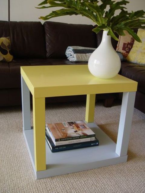 a bold and contrasting IKEA Lack table hack of two pieces in grey and bold yellow is a catchy touch of color to the space