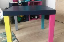 a colorful IKEA Lack table hack with a black tabletop and mismatching colorful legs is a great idea for a bold room
