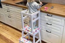 a colorful learning tower made of an IKEA Bekvam and Oddvar stool spruced up with bold polka dots