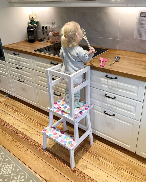 a colorful learning tower made of an IKEA Bekvam and Oddvar stool spruced up with bold polka dots