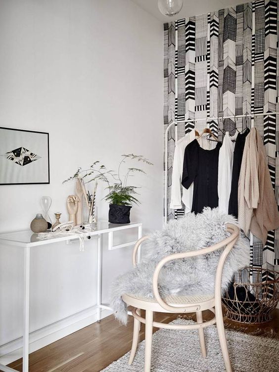 a cozy makeup nook in the walk-in closet, with a white Vittsjo desk, a neutral chair, greenery, bulbs and some decor is a lovely space