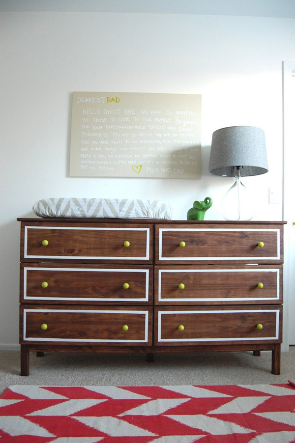 a dark stained IKEA Tarva dresser with white inlays and bright yellow knobs is a stylish dressing table