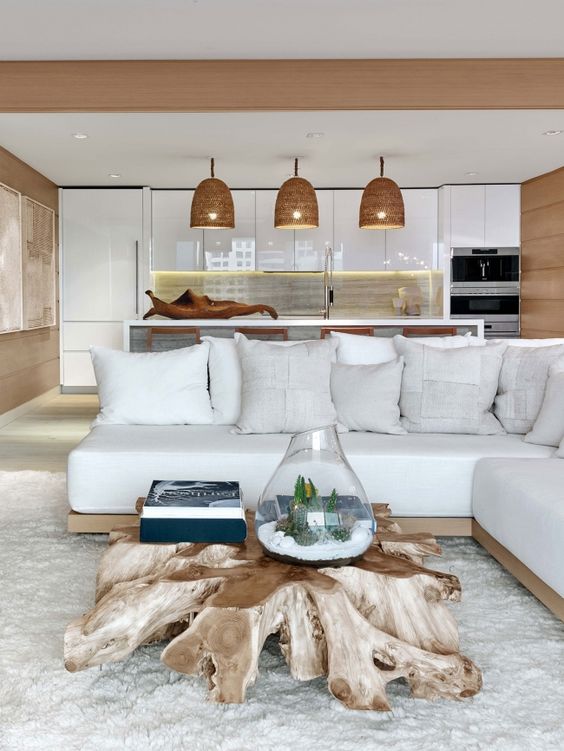 a driftwood coffee table is a gorgeous statement for a modern beach or coastal interior and it looks really jaw-dropping