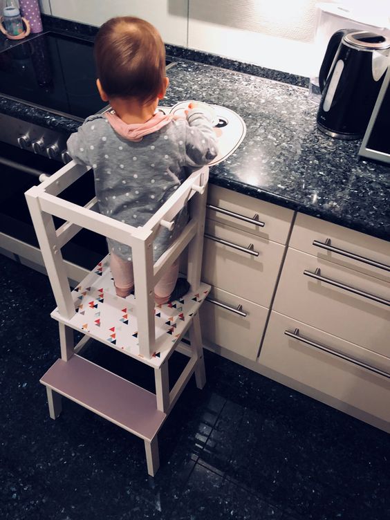 a learning tower made of an IKEA Bekvam and Oddvar stool hacked with mauve paint and triangle stencils